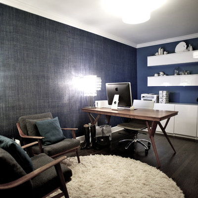 Example of a trendy freestanding desk dark wood floor home office design in Vancouver with blue walls