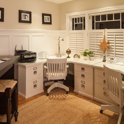 Inspiration for a timeless built-in desk medium tone wood floor home office remodel in Vancouver with beige walls