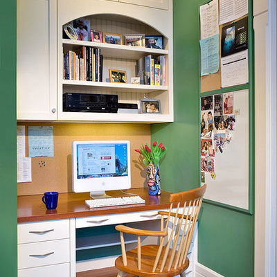 Example of a small classic built-in desk medium tone wood floor and brown floor study room design in Boston with green walls and no fireplace
