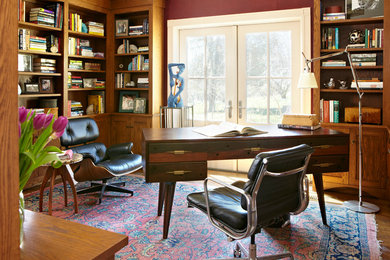 Photo of a retro study in Boston with red walls, medium hardwood flooring and a freestanding desk.