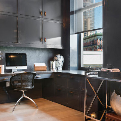 Study room - large contemporary built-in desk medium tone wood floor and brown floor study room idea in New York with blue walls