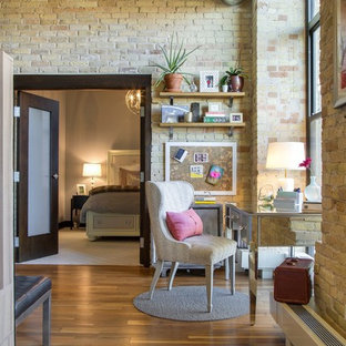 Urban freestanding desk medium tone wood floor home office photo in Minneapolis