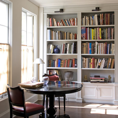 Elegant freestanding desk dark wood floor home office photo in Los Angeles