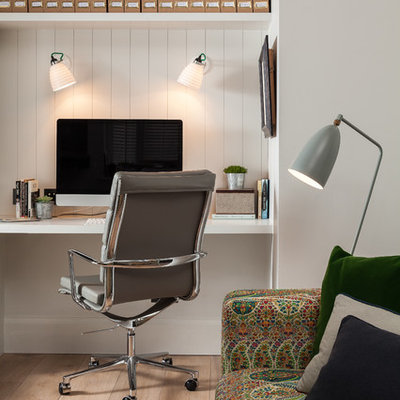 Example of a cottage built-in desk light wood floor study room design in Kent with white walls and no fireplace