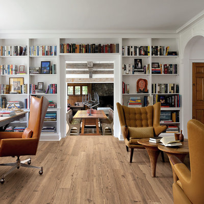 Transitional freestanding desk light wood floor home office library photo in London with white walls, a standard fireplace and a stone fireplace