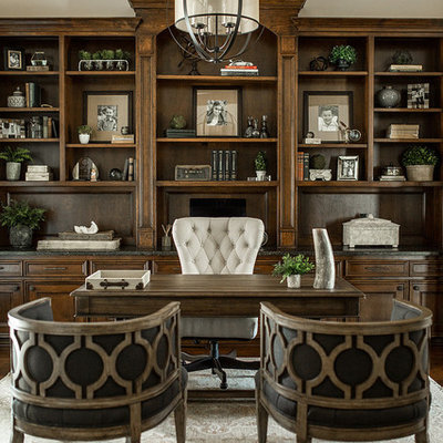 Example of a classic freestanding desk dark wood floor and brown floor study room design in Houston with beige walls