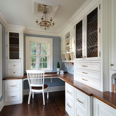 Elegant built-in desk home office photo in Minneapolis with blue walls
