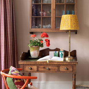 Inspiration for a small classic study in London with pink walls, a freestanding desk and grey floors.