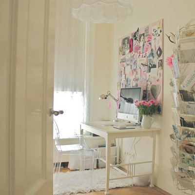 Home office - eclectic freestanding desk medium tone wood floor home office idea in Amsterdam with white walls
