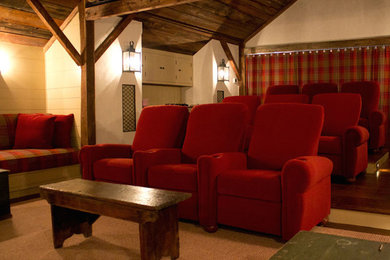 Example of a mid-sized mountain style open concept medium tone wood floor home theater design in New York with brown walls and a media wall