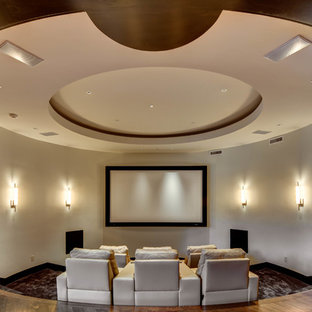 Modelo de cine en casa cerrado, tradicional renovado, extra grande, con paredes beige, moqueta y pantalla de proyección
