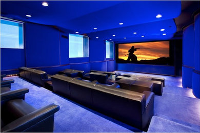 Example of a mid-sized urban enclosed carpeted and blue floor home theater design in Los Angeles with blue walls and a projector screen