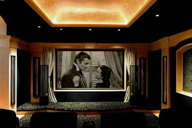 This is an example of a large traditional enclosed home cinema in Houston with green walls and a wall mounted tv.