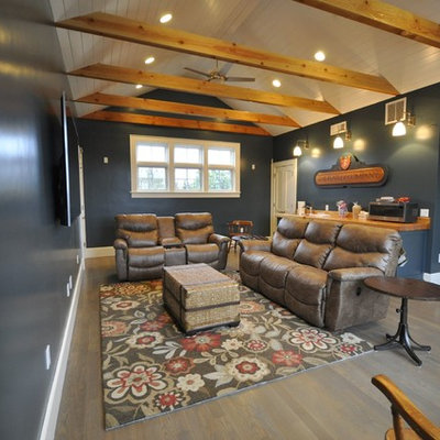 Example of a mid-sized transitional open concept light wood floor and gray floor home theater design in Other with blue walls and a wall-mounted tv