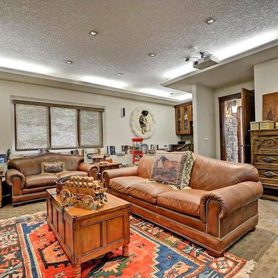 Inspiration for a large southwestern enclosed carpeted and beige floor home theater remodel with white walls and a projector screen