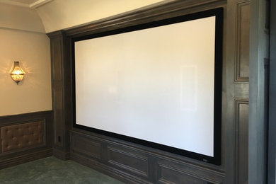 Inspiration for a carpeted home theater remodel in Phoenix with beige walls and a projector screen