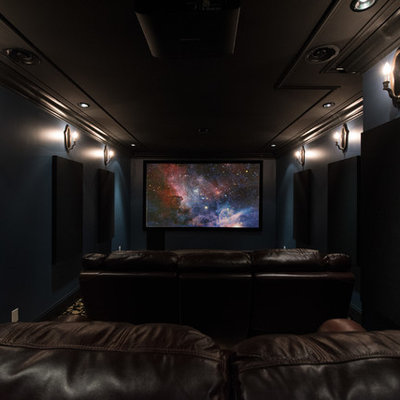 Example of a mid-sized classic enclosed carpeted and black floor home theater design in Vancouver with blue walls and a projector screen
