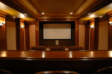 Home theater - large traditional enclosed carpeted home theater idea in Raleigh with brown walls and a projector screen