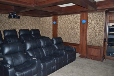 Mid-sized elegant enclosed carpeted home theater photo in DC Metro with brown walls and a projector screen