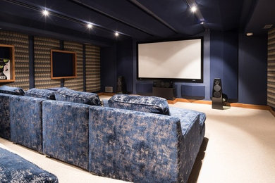 Inspiration for a large modern enclosed home theater remodel in Grand Rapids with a projector screen