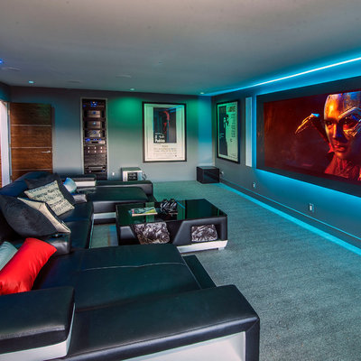 Large trendy enclosed carpeted and gray floor home theater photo in San Francisco with gray walls and a projector screen
