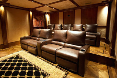 Example of a mid-sized enclosed light wood floor home theater design in Other with beige walls and a wall-mounted tv