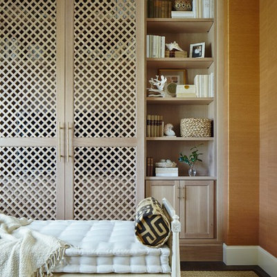 Example of a large beach style enclosed dark wood floor home theater design in Miami with orange walls and a media wall