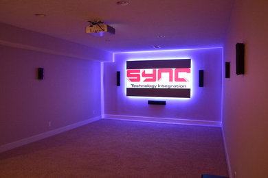 Large minimalist open concept carpeted home theater photo in Indianapolis with a projector screen and beige walls
