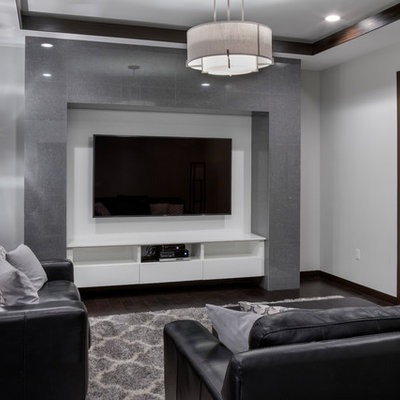 Mid-sized trendy open concept dark wood floor and brown floor home theater photo in Orlando with gray walls and a wall-mounted tv