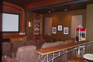 Modelo de cine en casa clásico de tamaño medio con paredes rojas y suelo de madera clara
