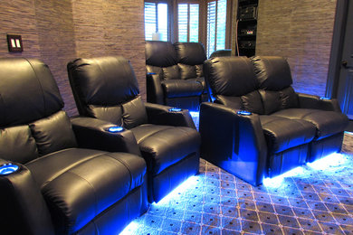 Home theater - mid-sized transitional enclosed carpeted and multicolored floor home theater idea in Dallas with a wall-mounted tv