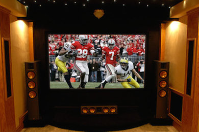 Design ideas for a traditional enclosed home cinema in Columbus with yellow walls, carpet and a built-in media unit.