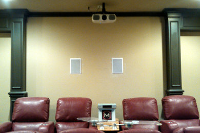 Home theater - enclosed home theater idea in Kansas City with beige walls and a projector screen