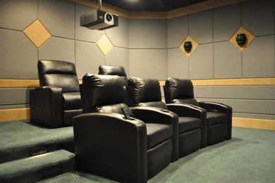 Inspiration for a mid-sized enclosed carpeted home theater remodel in Jacksonville with gray walls and a projector screen