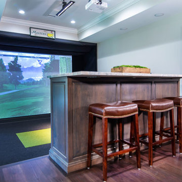 Golf simulator and bar area in basement of mountain home.
