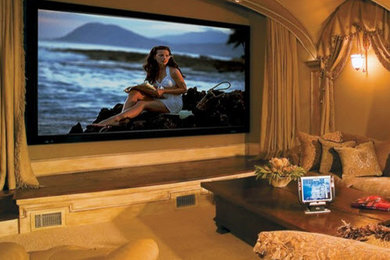 Home theater - large traditional enclosed ceramic tile and beige floor home theater idea in Atlanta with beige walls and a media wall