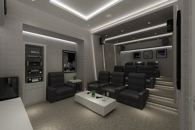 Foto de cine en casa cerrado contemporáneo de tamaño medio con paredes grises, moqueta y televisor colgado en la pared