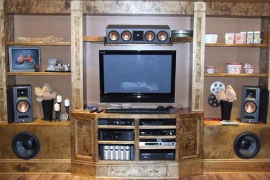 Example of a mid-sized enclosed home theater design in Other with brown walls and a wall-mounted tv