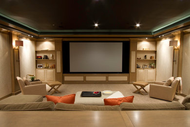 Ejemplo de cine en casa cerrado tradicional extra grande con paredes beige, moqueta y pantalla de proyección
