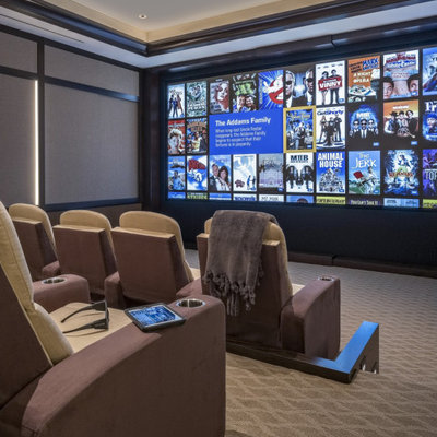 Home theater - large traditional enclosed carpeted and multicolored floor home theater idea in Miami with beige walls and a projector screen