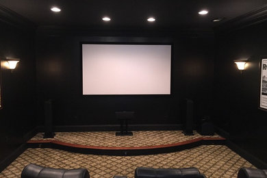 Home theater - large traditional enclosed carpeted and brown floor home theater idea in Atlanta with beige walls and a wall-mounted tv