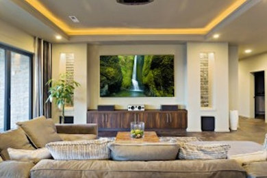 Ejemplo de cine en casa clásico de tamaño medio con paredes amarillas, suelo de cemento y televisor colgado en la pared