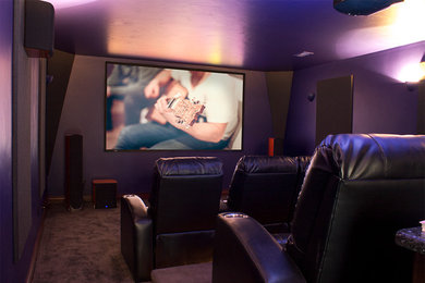Inspiration for a large transitional enclosed carpeted home theater remodel in Other with purple walls and a projector screen