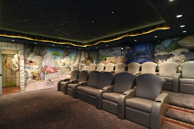 Inspiration for a large world-inspired enclosed home cinema in Cincinnati with multi-coloured walls, carpet, a projector screen and brown floors.