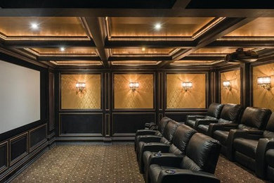 Photo of an expansive traditional enclosed home cinema in Orange County with brown walls, carpet, a projector screen and brown floors.