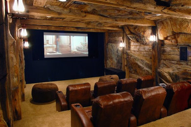 Carpeted home theater photo in Los Angeles with brown walls and a projector screen