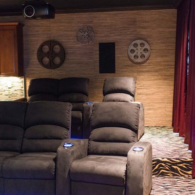 Large elegant enclosed carpeted and multicolored floor home theater photo in Charlotte with a projector screen and beige walls
