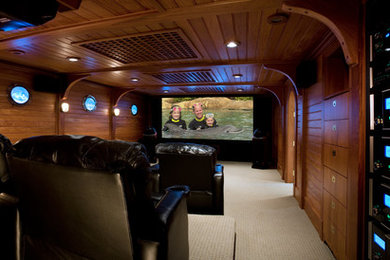 Large trendy enclosed carpeted home theater photo in Portland Maine with a projector screen