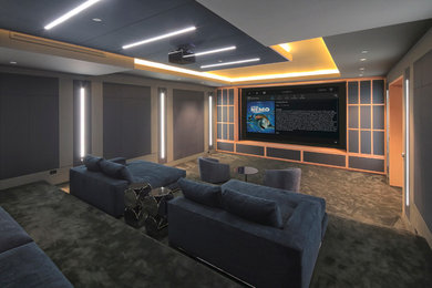 Inspiration for a large transitional enclosed carpeted and gray floor home theater remodel in Salt Lake City with gray walls and a projector screen