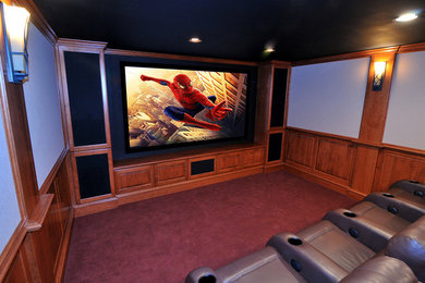 Photo of a medium sized traditional enclosed home cinema in Cleveland with a projector screen.